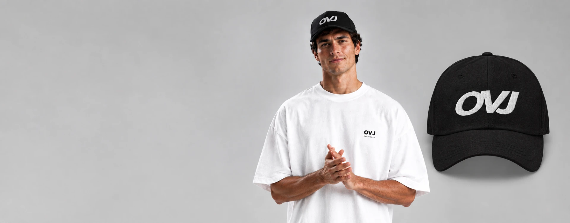 Model wearing an Over Jesus white tee and OVJ black cap